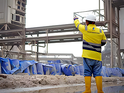 Technician inspecting installed chromium carbide overlay wear liners at an industrial site